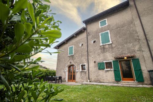 an external view of a building with green shutters at BOSSEMA 8 Home in Calmasino