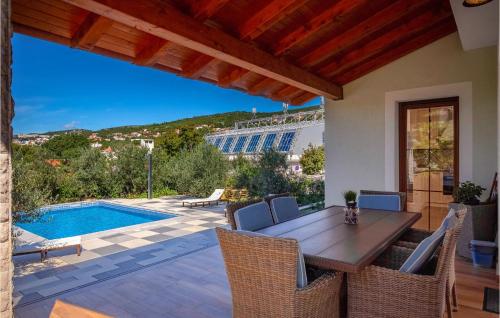 a patio with a table and chairs and a pool at 3 Bedroom Lovely Home In Kostrena in Kostrena