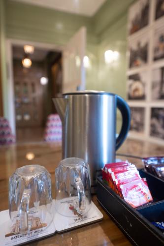 a table with a coffee pot and a cup on it at Theory9 Premium Service Apartments Bandra in Mumbai