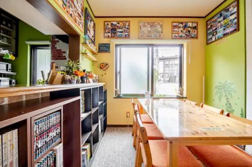 a dining room with a table and chairs at Guesthouse Murabito in Yamanakako
