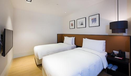 Postel nebo postele na pokoji v ubytování Citadines South Chengdu
