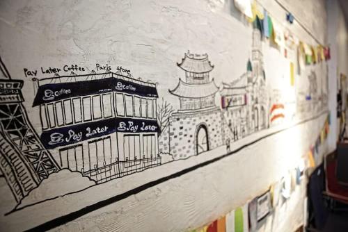 a drawing of a building on a wall at Jeonju Hostel in Jeonju