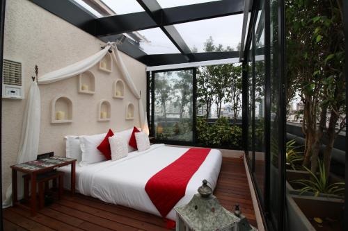 a bedroom with a bed and a large window at Theory9 Premium Service Apartments Bandra in Mumbai