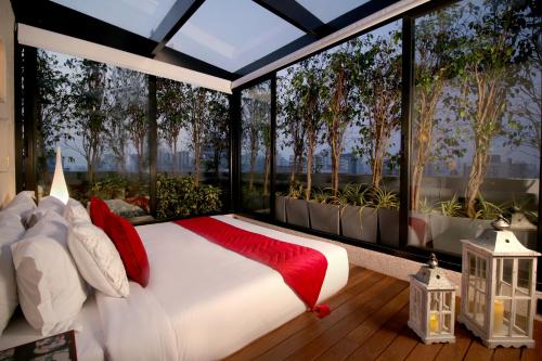 a bedroom with a bed with a large window at Theory9 Premium Service Apartments Bandra in Mumbai