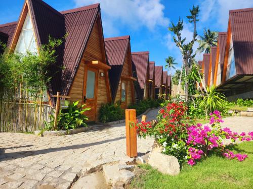 a row of houses with flowers in front of them at Fly Up Resort in Lai Sơn