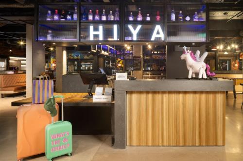 a bar with a unicorn statue on top of a counter at Moxy Cork in Cork