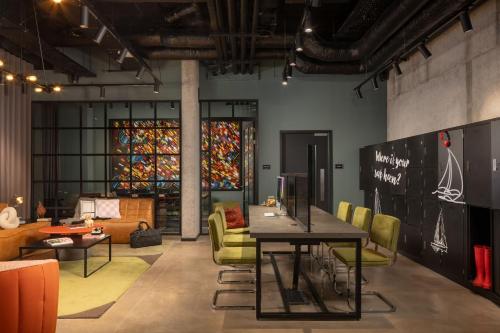 a room with a table and chairs and a stained glass window at Moxy Cork in Cork