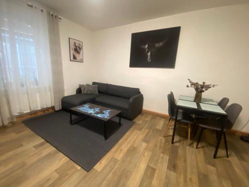 a living room with a couch and a table at Černý Tulipán - Apartmán 2 in Plzeň