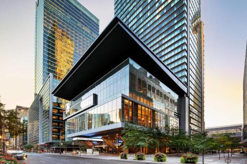a building in a city with tall buildings at The Ritz-Carlton, Toronto in Toronto