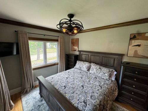 a bedroom with a bed and a window and a chandelier at Mayo Clinic - 3 King bed - 2 Full Bath - Free Park in Rochester