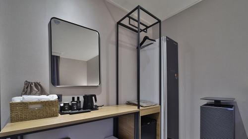 a bathroom with a counter with a mirror and a sink at Jeonju It's Hotel in Jeonju