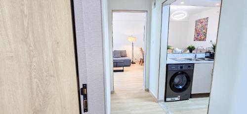 a room with a washing machine in a kitchen at Marina View Spacious 2 BHK in Dubai