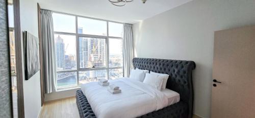 a bed in a room with a large window at Marina View Spacious 2 BHK in Dubai