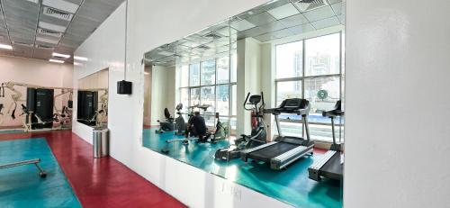 a gym with treadmills and ellipticals in a building at Marina View Spacious 2 BHK in Dubai