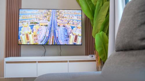 a flat screen tv sitting in a living room at Marina View Spacious 2 BHK in Dubai