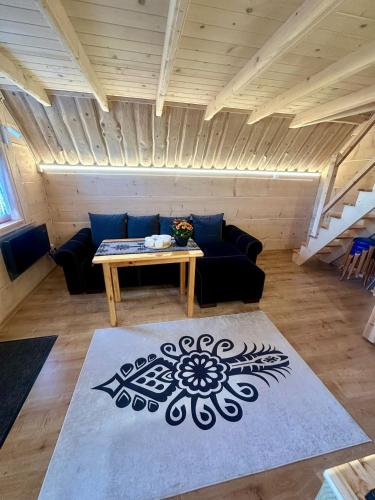 a living room with a couch and a table at Domki Salamonki in Kościelisko
