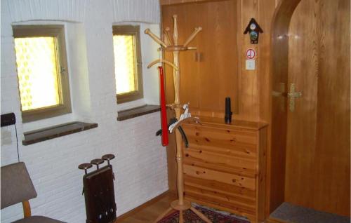 a room with a wooden door and a cross on the wall at Holiday Home Am Einsberg Q in Tellerhäuser
