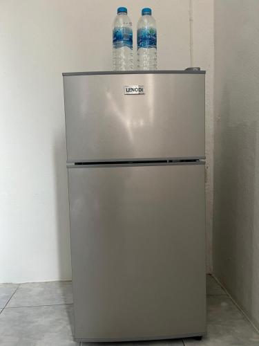 two bottles of water sitting on top of a refrigerator at Lo Sfizio in Patong Beach