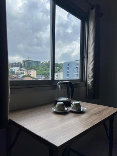 a table with two plates of food and a window at Lo Sfizio in Patong Beach