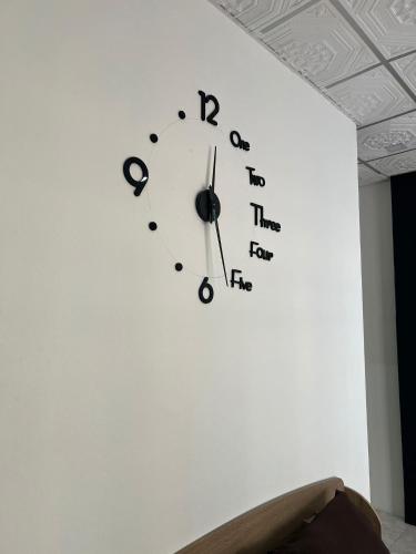 a clock on a wall with letters on it at Lo Sfizio in Patong Beach