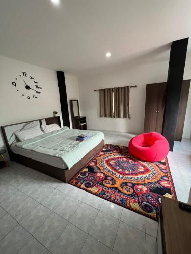 a bedroom with a bed with a red pillow on a rug at Lo Sfizio in Patong Beach