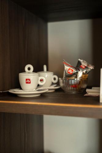 a shelf with two coffee cups and a basket on it at Hotel San Remo in Rome