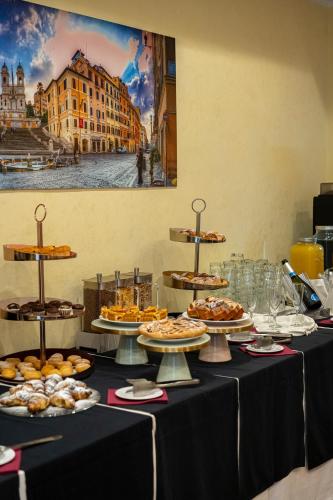 a table with plates of food on top at Hotel San Remo in Rome