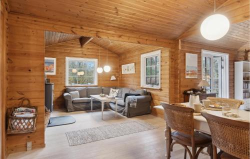 a living room with wooden walls and wooden floors at Stunning Home In Ålbæk With Wifi in Ålbæk