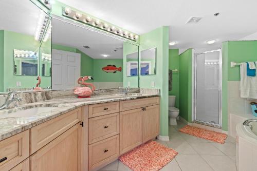 a bathroom with two sinks and a large mirror at Oceanwalk 2-202 in New Smyrna Beach