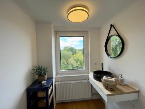 a bathroom with a sink and a window at Haus Königsee "Seeblick" in Bad Oldesloe