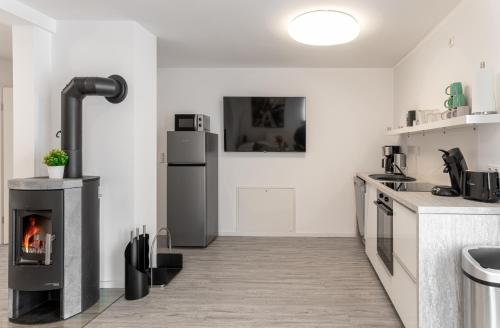 a kitchen with a fireplace in the middle of it at Glück in Zinnowitz
