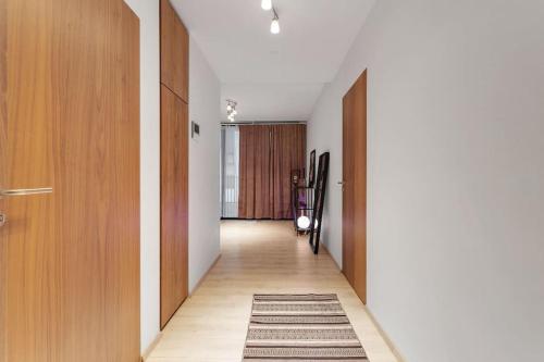 a hallway with wooden doors and a rug at Premium apartment Queen downtown in Reykjavík