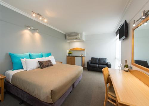 a bedroom with a bed and a desk and a chair at Berri Hotel in Berri