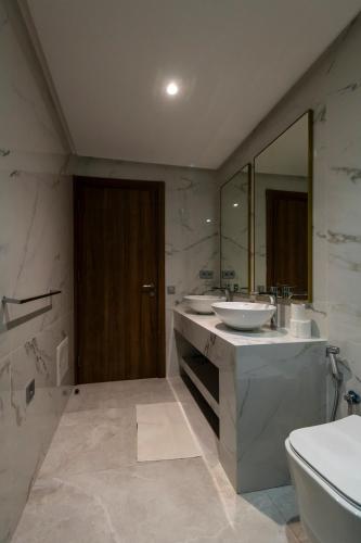 a bathroom with two sinks and a large mirror at Luxury Duplex 3 Suites -Front Pool-Direct Pool Access in Marrakesh