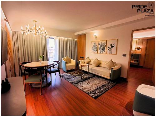 a living room with a couch and a table at Pride Plaza Hotel, Ahmedabad in Ahmedabad
