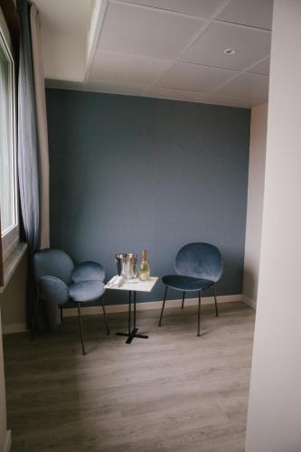 a room with two blue chairs and a table at Best Western Regina Elena in Santa Margherita Ligure