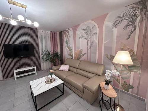 a living room with a couch and a table at Esprit Palace, coeur de Mulhouse in Mulhouse