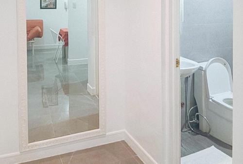 a bathroom with a toilet and a mirror at RedDoorz at The Providence Tower in Manila