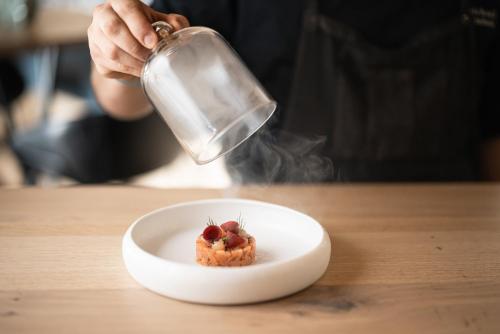 a person holding a glass jar over a dessert at DAS GERSTL Alpine Retreat in Malles Venosta