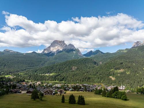 a town in a valley with mountains in the background at Hotel il Cardo in San Vito di Cadore