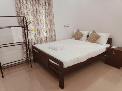 a bedroom with a bed and a bunk bed at Palm Paradise Home Stay in Varkala