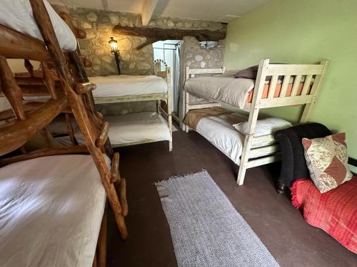 a room with a bunch of bunk beds in it at Stormsriver Backpackers Dijembe in Stormsrivier
