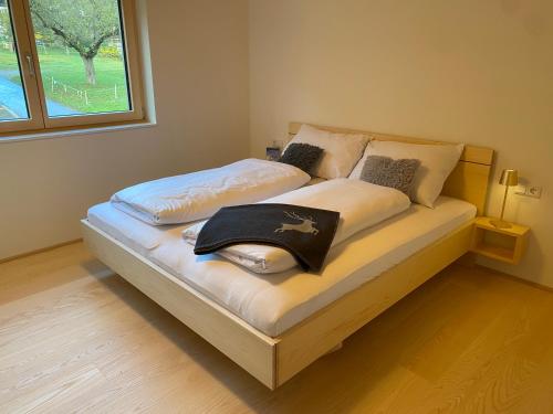 a bedroom with two beds with a window at AlpenApart Montafon - Alti Saga in Tschagguns
