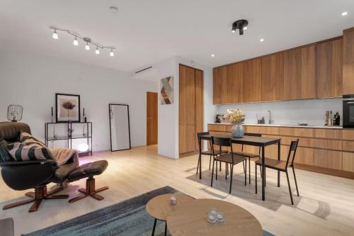 a living room and kitchen with a table and chairs at Premium apartment Queen downtown in Reykjavík