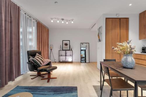a living room with a table and a chair at Premium apartment Queen downtown in Reykjavík