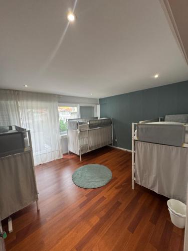 a room with two bunk beds and a wooden floor at Dormitório Aliados in Porto
