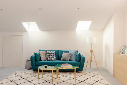 a living room with a blue couch and a table at Olaf in Lyon