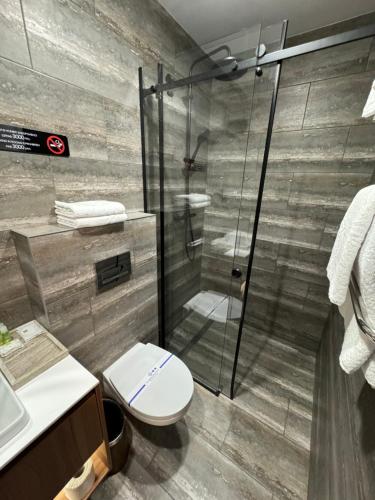 a bathroom with a toilet and a glass shower at Alir in Zhytomyr