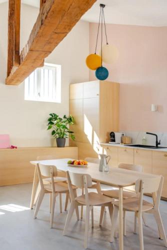 a white dining room table and chairs in a kitchen at Olaf in Lyon