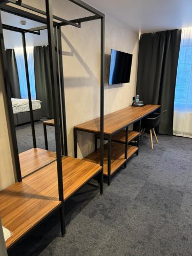 a room with a desk and a mirror and a bed at Alir in Zhytomyr